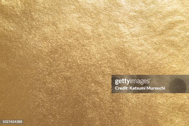 golden foil paper texture background - gold colored ストックフォトと画像