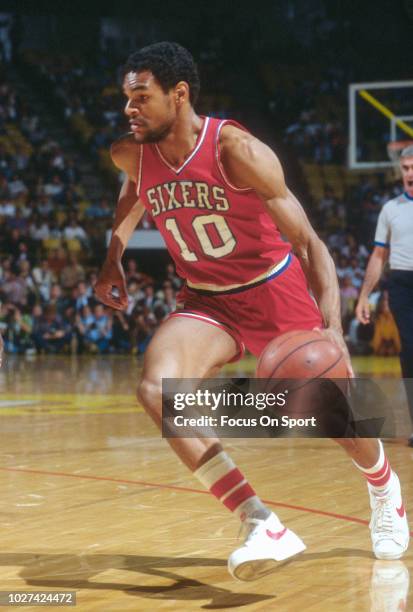 Maurice Cheeks of the Philadelphia 76ers dribbles the ball against the Los Angeles Lakers during an NBA basketball game circa 1983 at The Forum in...