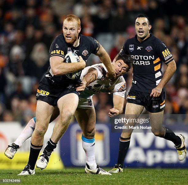 Keith Galloway of the Tigers runs the ball during the round 18 NRL match between the Wests Tigers and the Gold Coast Titans at Campelltown Sports...