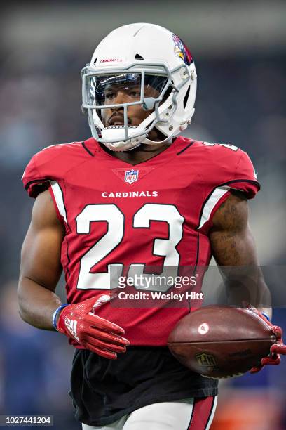 Bene Benwikere of the Arizona Cardinals warms up before a game against the Dallas Cowboys at AT&T Stadium during week 3 of the preseason on August...