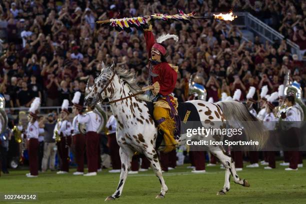 Florida State's Osceola and Renegade ride out to midfield with a flaming spear before the game between the Florida State Seminoles and the Virginia...