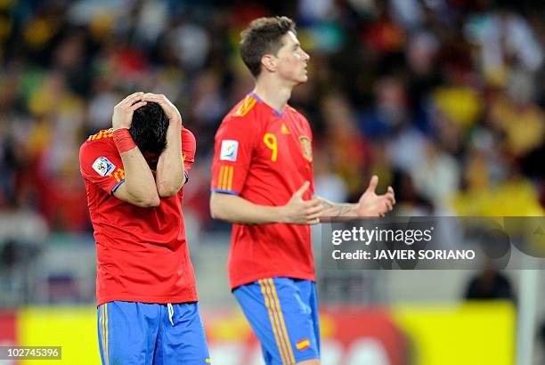 Spain's striker David Villa reacts next to teammate Fernando Torres after missing a chance to score against Switzerland during their 2010 World Cup...