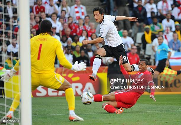 Germany's midfielder Mesut Ozil vies with England's defender Ashley Cole as he shoots at England's goalkeeper David James during the 2010 World Cup...