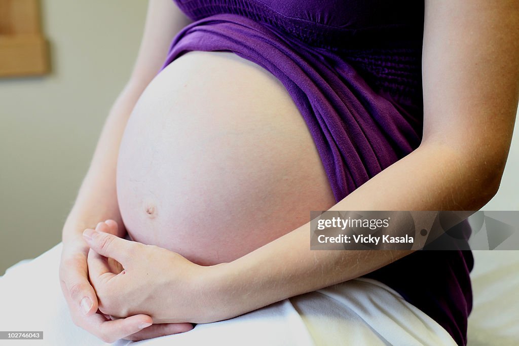 Pregnant woman's stomache, close-up.