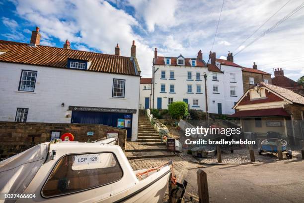 historic coastguard station and boats in robin hood's bay, uk - robin hood's bay imagens e fotografias de stock