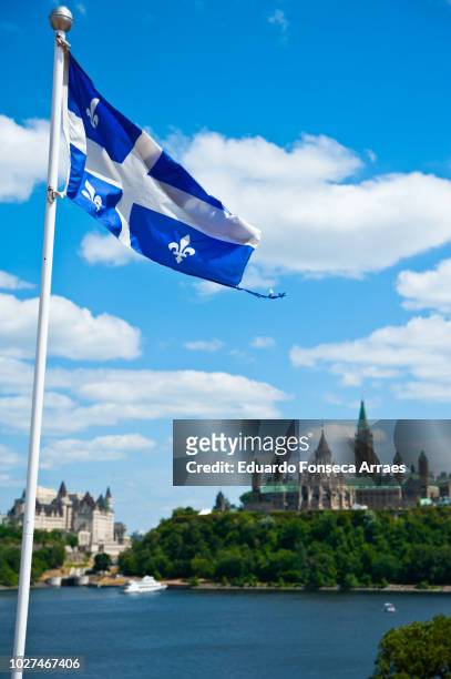 québec flag and canadian parliament - quebec parliament stock pictures, royalty-free photos & images