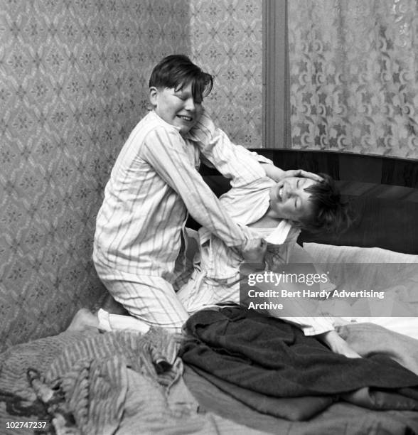 Two boys fighting in their bedroom, 10th February 1958.
