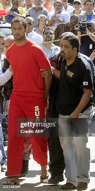 Brazilian footballer Bruno Fernandes de Souza is taken under custody to the presidium of Belo Horizonte, Brazil, on July 9, 2010. De Sousa, a star...