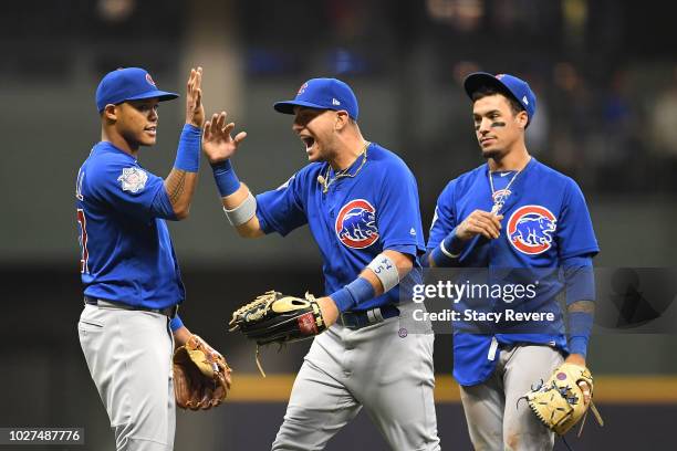 Albert Almora Jr. #5 of the Chicago Cubs celebrates a victory over the Milwaukee Brewers with Addison Russell at Miller Park on September 5, 2018 in...