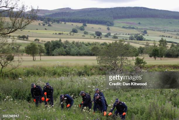 Police officers conduct a search in bushes as part of the ongoing search for Raoul Moat on July 9, 2010 in Rothbury, England. Police continue to...