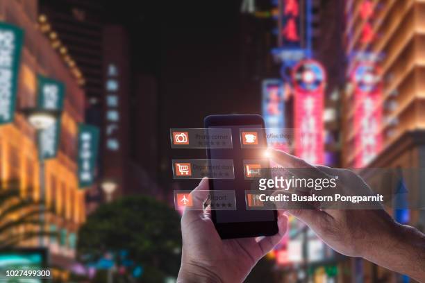hand holding smart phone use ar application to check relevant information about the spaces around customer. - digital store imagens e fotografias de stock