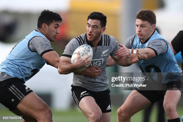 Nehe Milner-Skudder of the All Blacks is tackled by Rieko Ioane and Beauden Barrett during a New Zealand All Blacks training session at Trafalgar...