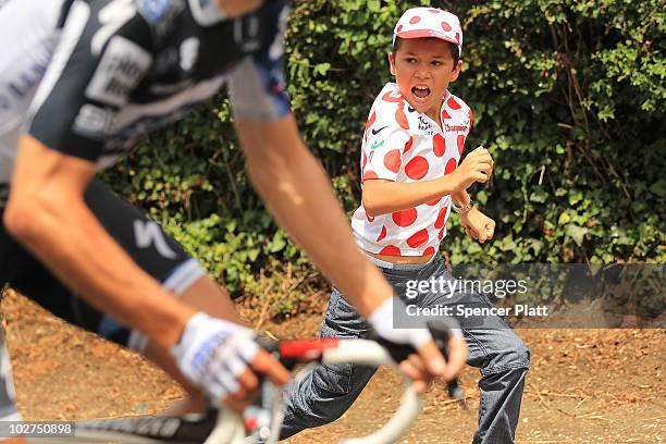 Young boy chases the peloton along the 227.5km route from Montargis to Gueugnon in stage six of the Tour de France July 9, 2010 in Gueugnon, France....