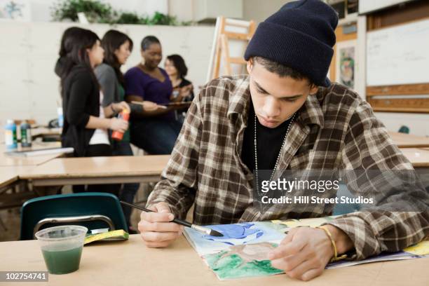 students painting in art class - male artist painting stock pictures, royalty-free photos & images