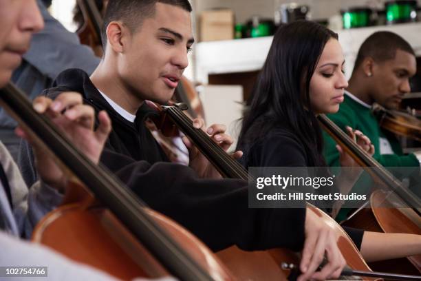 students practicing in high school orchestra - rehearsing lines stock pictures, royalty-free photos & images