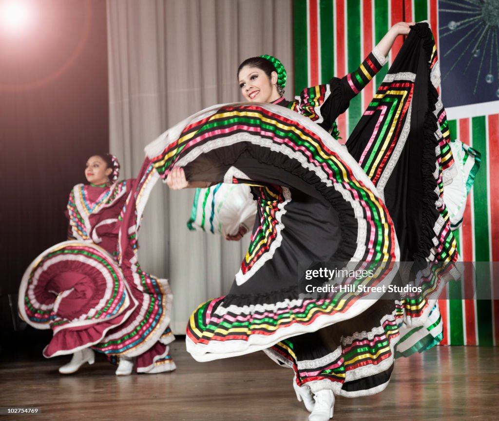 Students performing Mexican folk dance on stage