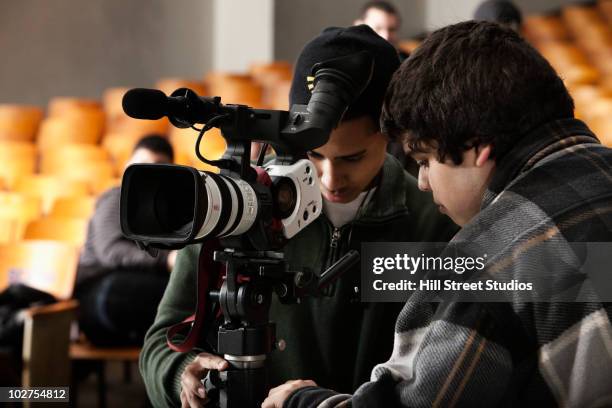 students adjusting video camera equipment - camera man stock pictures, royalty-free photos & images