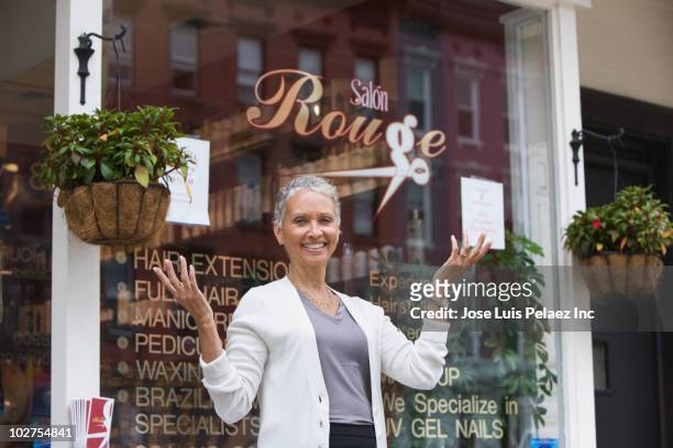 african american beauty salon owner standing outdoors - hairdressers black woman stock pictures, royalty-free photos & images