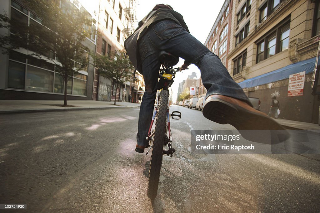Caucasian man riding bicycle on urban street