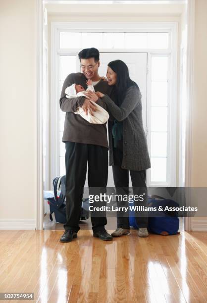 chinese parents bringing home newborn baby girl - baby arrival stock pictures, royalty-free photos & images