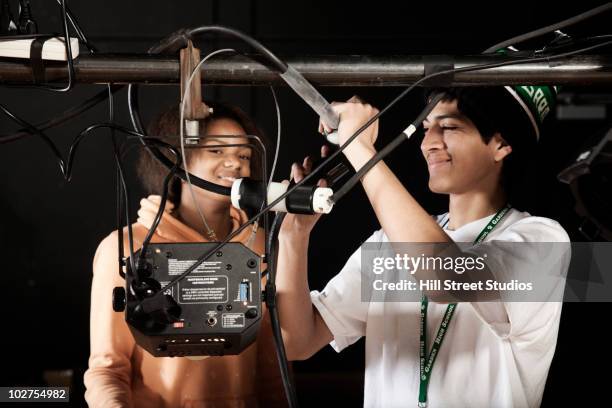 students adjusting equipment backstage - stage lighting equipment stock pictures, royalty-free photos & images