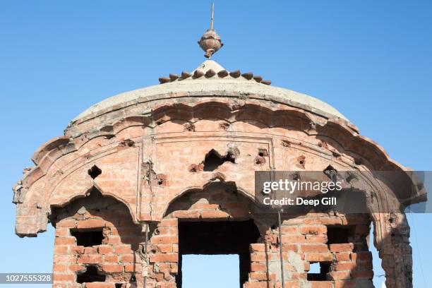 a bullet-ridden pillar at the golden temple (also known as sri harmandir sahib gurdwara) during the vaisakhi festival in amritsar, punjab, india - amritsar stock pictures, royalty-free photos & images