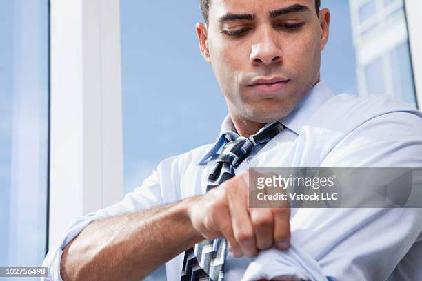 businessman rolling up his sleeves - sleeve roll stock pictures, royalty-free photos & images