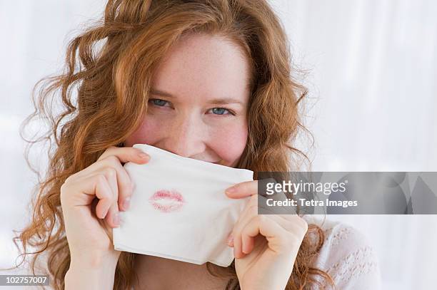 woman holding tissue with lipstick on it - lipstick stain stock pictures, royalty-free photos & images