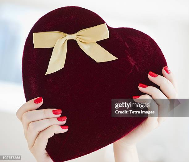 hands holding a heart shaped box - chocolate pieces stock pictures, royalty-free photos & images