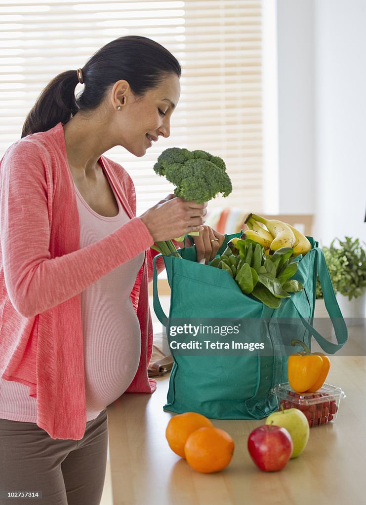 Pregnant woman unpacking groceries
