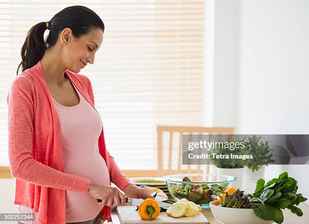 pregnant woman making salad - pregnancy healthy eating stock pictures, royalty-free photos & images