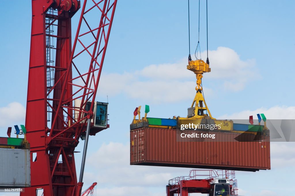 Crane lifting shipping container