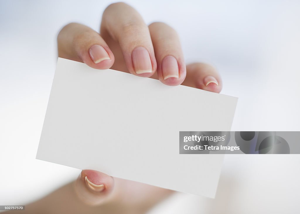 Hand holding a blank business card