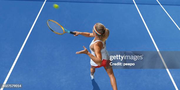 tennis player from above playing tennis on blue hard court - blue tennis racket stock pictures, royalty-free photos & images