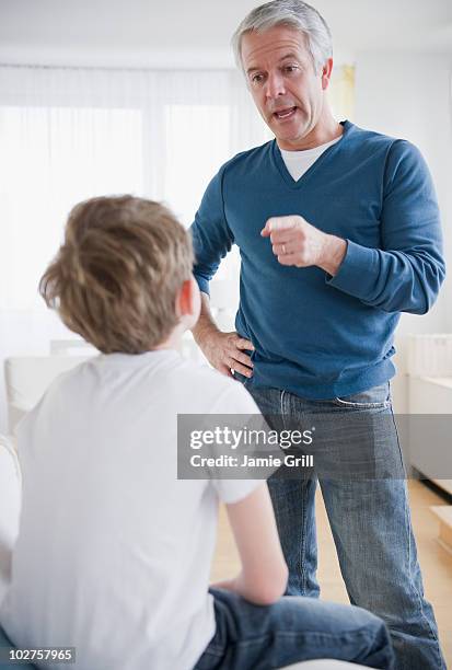 father disciplining son - scolding stock pictures, royalty-free photos & images