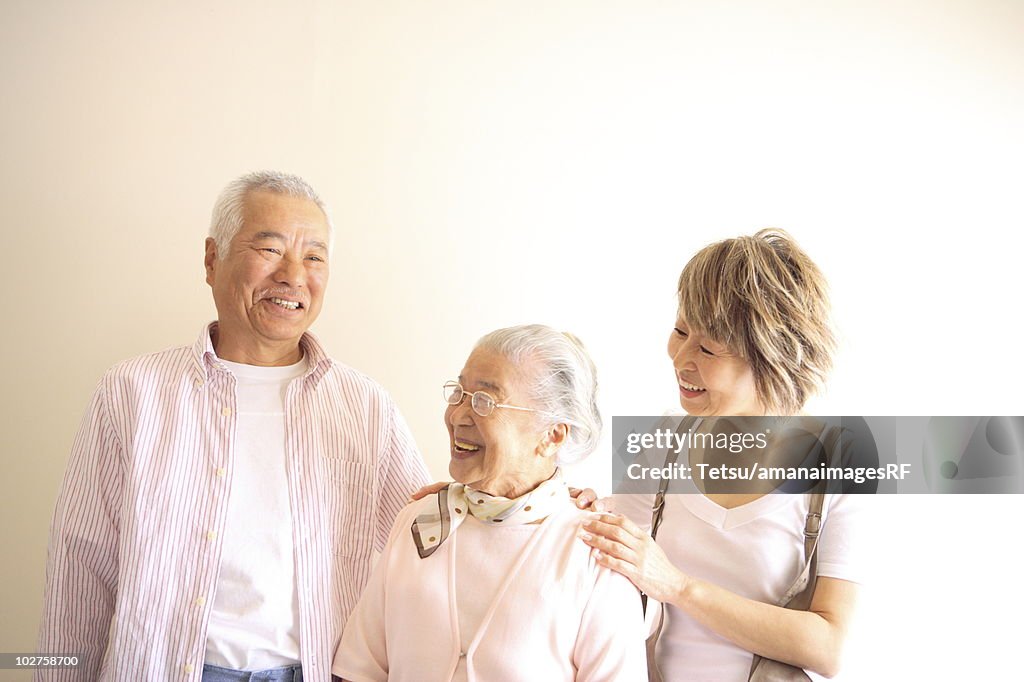 Two generation family, smiling, white background