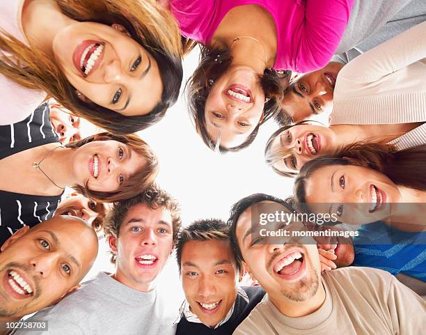 people standing in a circle - multiculturalism faces stock pictures, royalty-free photos & images