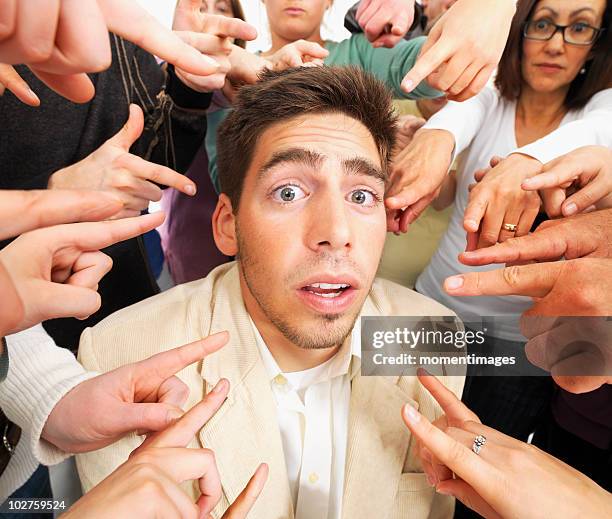 group of people pointing at one person - condemn stock pictures, royalty-free photos & images