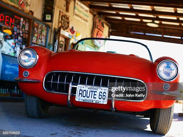 antique red convertible car - license plate stockfoto's en -beelden