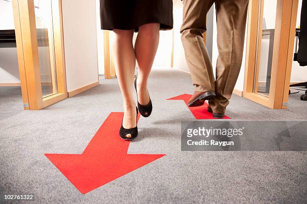 people walking in different directions - following arrows stock pictures, royalty-free photos & images