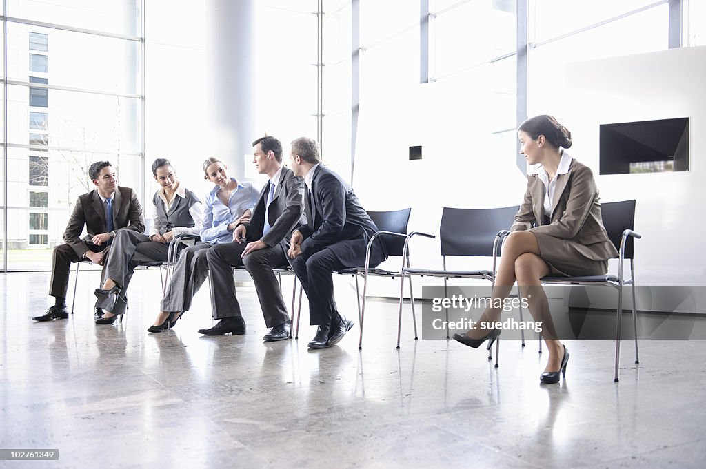 Woman sitting alone separate from group