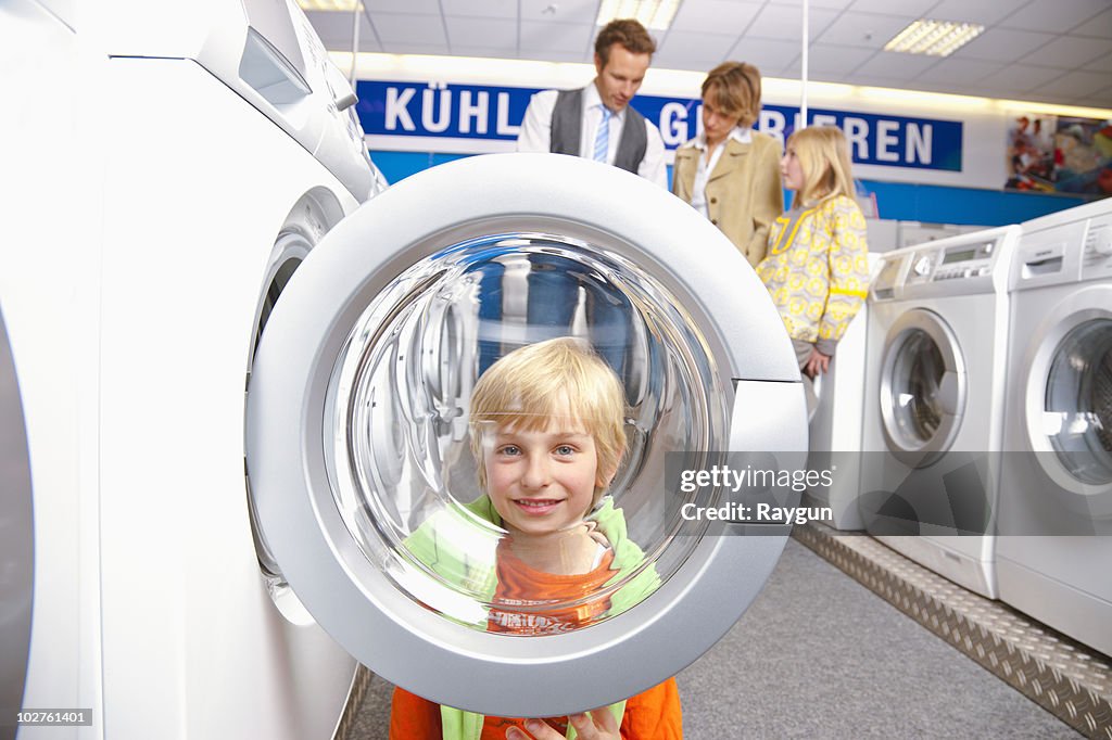 Boy looking through machines' bulls eye