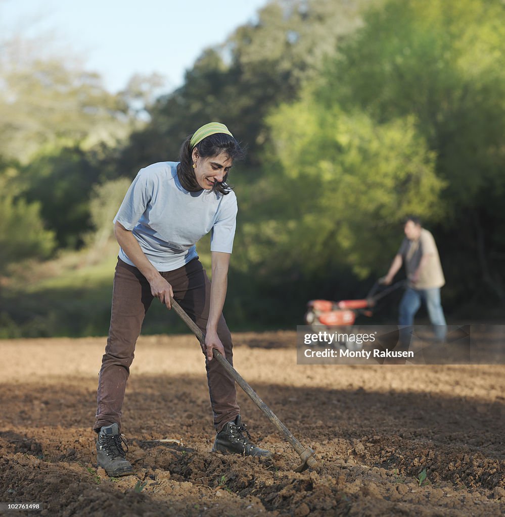 Man and woman preparing soil for sowing