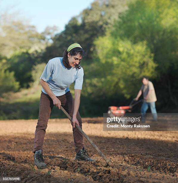 man and woman preparing soil for sowing - get your hoe ready stock pictures, royalty-free photos & images