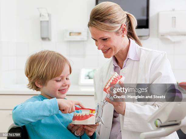 dentist with boy in surgery - dentista bambini foto e immagini stock