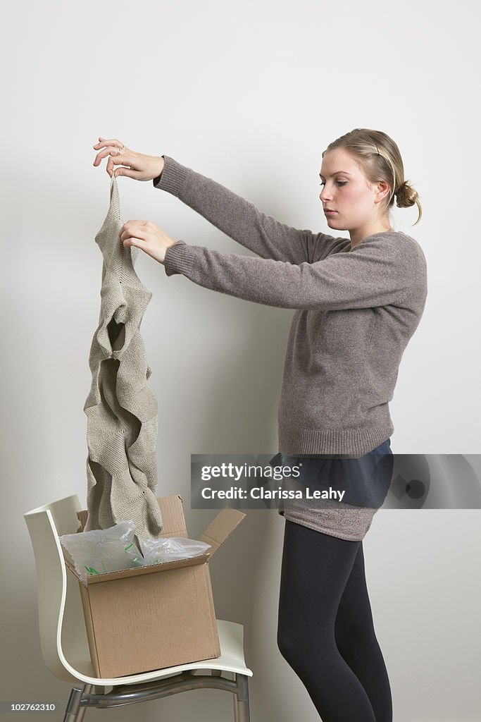 Woman taking scarf out of box