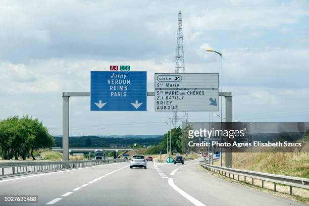 motorway exit and directional road sign in france - exit sign stock-fotos und bilder