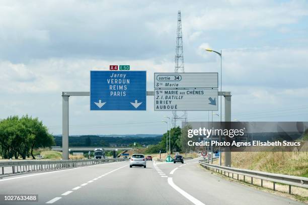 motorway exit and directional road sign in france - exit sign photos et images de collection