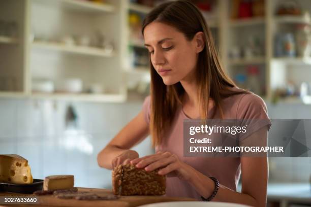 woman in the kitchen - wholemeal bread stock pictures, royalty-free photos & images