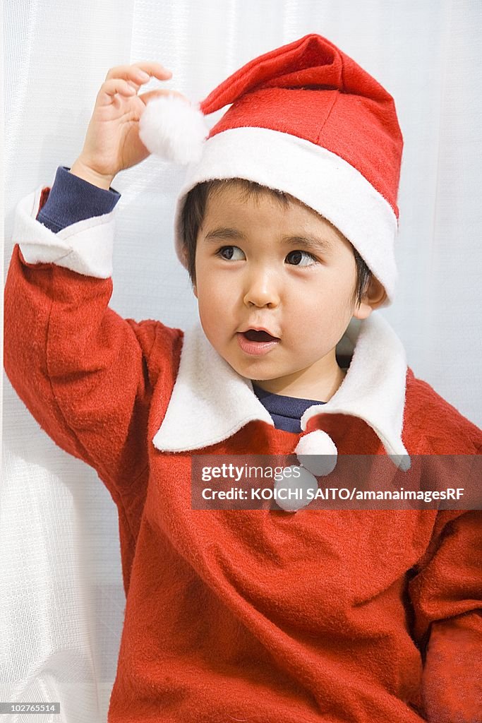 Young boy in Santa suit